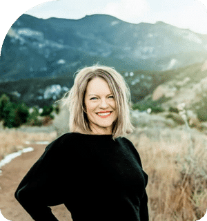 Doctor Jana Gainok smiling outdoors with mountains in the background